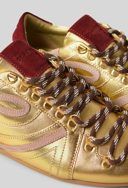 Goldene Swing-Sneaker