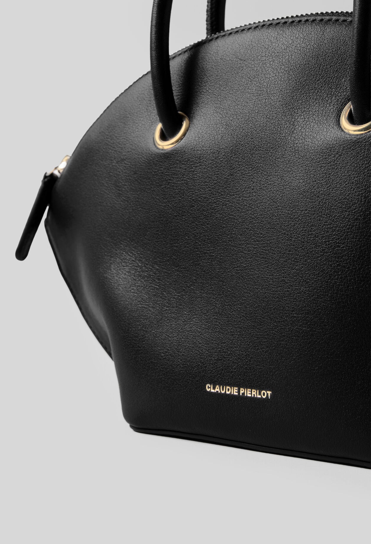 Glattledertasche mit Goldringen